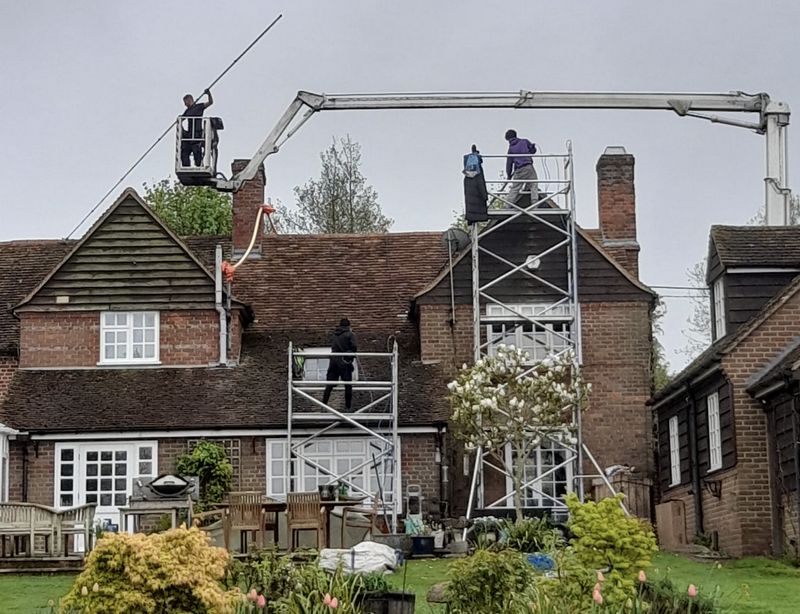 The Moss Cleaners using cherry picker and scaffolding to clean roof safely and professionally in Marlborough, Wiltshire
